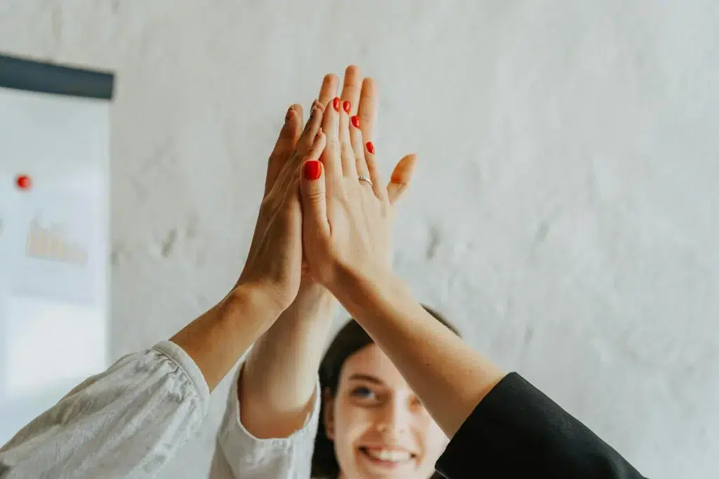 Three people give each other a high-five